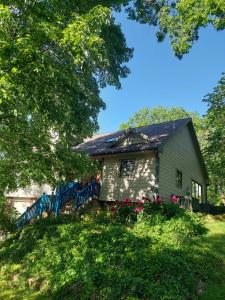 a small green house with a roof at Cirque Stay in Lawrence
