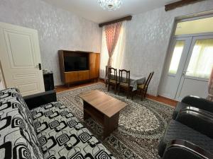 a living room with a couch and a table at Aviator Apartment in Bina