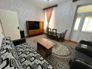 a living room with a couch and a table at Aviator Apartment in Bina