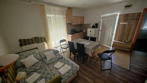 a living room with a couch and a table with chairs at Ezee Rider Apartmanok in Sárvár +29 photos