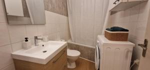 a white bathroom with a sink and a toilet at Le Cocon de la Prom in Nice