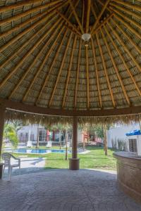a large wooden pavilion with a bench in a park at Casas Diamante in Xochitepec
