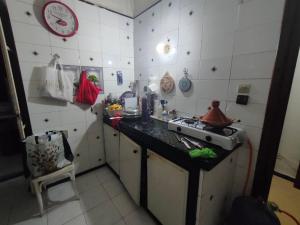 a small kitchen with a sink and a stove at Chambre Cosy Climatisé, Romantique et indépendante chez l'habitant in Tangier +41 photos