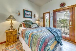 a bedroom with a bed and a balcony at Comfy Aspen Ridge Home about 3 Mi to Ski Lifts in Cloudcroft