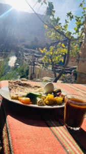 a plate of food with an egg on a table at TOWER Hotel in Dana