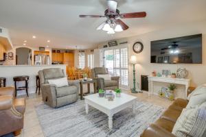 a living room with a couch and a table at Pool, Patio and Hot Tub Surprise Home Near Golfing! in Surprise