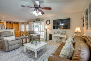 a living room with a couch and a ceiling fan at Pool, Patio and Hot Tub Surprise Home Near Golfing! in Surprise