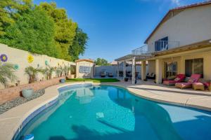 a swimming pool in front of a house at Pool, Patio and Hot Tub Surprise Home Near Golfing! in Surprise