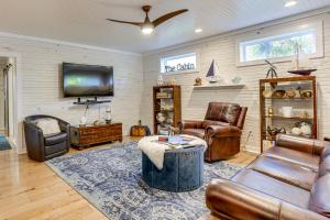a living room with leather furniture and a flat screen tv at Walk to Marina and Beach Charming Home in Hardin in Aurora