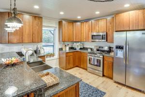 a kitchen with wooden cabinets and a stainless steel refrigerator at Walk to Marina and Beach Charming Home in Hardin in Aurora