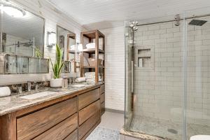 a bathroom with two sinks and a shower at Walk to Marina and Beach Charming Home in Hardin in Aurora +16 photos