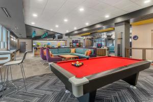 a pool table in a room with couches and a billiards at Tru By Hilton Goodlettsville Nashville in Goodlettsville