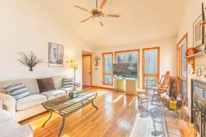 a living room with a couch and a table at Charming 3 bed 2 bath home near dunes, beach and trails in South Haven