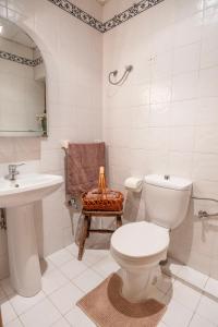 a white bathroom with a toilet and a sink at Spacious 3-Bedroom Apartment with Balconies-Central Sliema in Sliema +18 photos