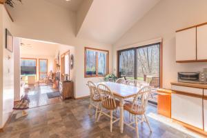 a kitchen and dining room with a table and chairs at Charming 3 bed 2 bath home near dunes, beach and trails in South Haven