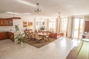 a dining room and living room with a table and chairs at Spacious 3-Bedroom Apartment with Balconies-Central Sliema in Sliema