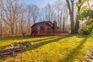 a log cabin in the middle of a grass field at Charming 3 bed 2 bath home near dunes, beach and trails in South Haven