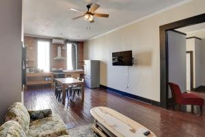 a living room with a couch and a table and a kitchen at Convenient Couples Retreat in Dtwn Marshall! in Marshall