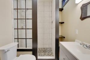 a bathroom with a shower and a toilet and a sink at Convenient Couples Retreat in Dtwn Marshall! in Marshall +16 photos