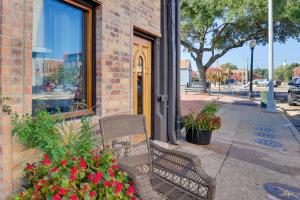 a bench sitting outside of a building with flowers at Convenient Couples Retreat in Dtwn Marshall! in Marshall