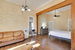 a living room with a bed and a couch at Pet-Friendly Studio in Historic Dtwn Marshall! in Marshall