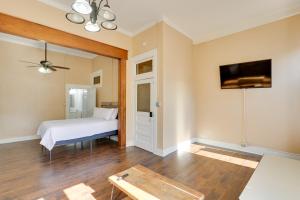 a bedroom with a bed and a flat screen tv at Pet-Friendly Studio in Historic Dtwn Marshall! in Marshall