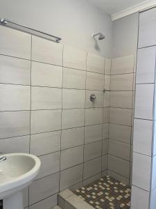 a bathroom with a shower and a sink at Kelpmeeu Self- Catering and Car hire in Swakopmund