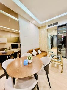 a living room with a wooden table and chairs at Dorsett Residences Executive KL in Kuala Lumpur