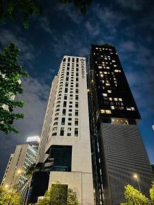 a tall building with lights on in a city at Dorsett Residences Executive KL in Kuala Lumpur +21 photos