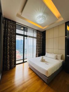 a bedroom with a large bed and a large window at Dorsett Residences Executive KL in Kuala Lumpur