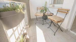 a balcony with a table and chairs and plants at Amber Apartman in Banja Koviljača