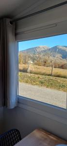 a window in a room with a view of a field at Le panoramique in Saillagouse