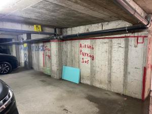 a parking garage with graffiti on the wall at The City of Dreams in Grevena +2 photos