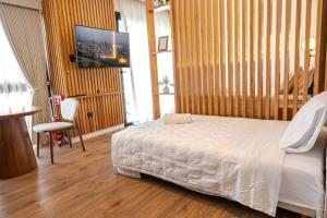 a bedroom with a white bed and wooden walls at Cozy apartment with fantastic gym and pool in Asuncion +22 photos