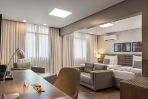 a living room with a couch and a table at Blue Tree Premium Florianópolis in Florianópolis