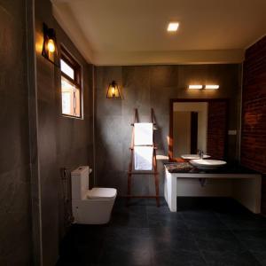 a bathroom with a toilet and a sink at Welpalla Signature 