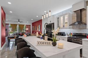 a kitchen with a large white counter with a coffee table at The Diamanti 3BD In the Heart of Dallas in Dallas