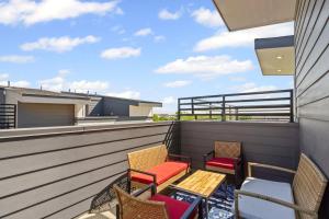 a patio with chairs and a table on a balcony at JoyFull 2BD In the Heart of Magnolia in Fort Worth