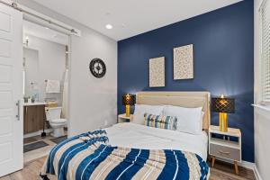 a bedroom with a bed and a blue wall at The Quartz 2BD Townhouse in the heart of FW in Fort Worth
