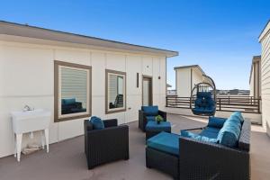 a patio with couches and a swing on a building at The Quartz 2BD Townhouse in the heart of FW in Fort Worth