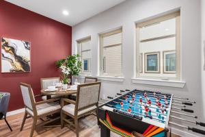 a dining room with a table and a large pool table at The Coral 2BD TownHouse 7ST Walkable in Fort Worth