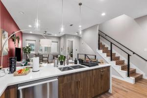a kitchen with a sink and a staircase at The Coral 2BD TownHouse 7ST Walkable in Fort Worth