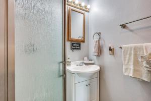 a bathroom with a shower and a sink and a mirror at 2 Mi to Dtwn Atascadero! Cozy Cottage with Yard in Atascadero +16 photos