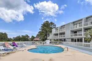 a view of the pool at a resort with lounge chairs and a hotel at Baytree Golf Colony Studio about 5 Mi to Beach! in Little River