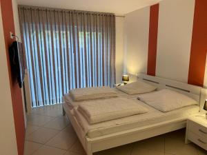 a bedroom with a bed and a large window at Wohnung 73 in Horumersiel