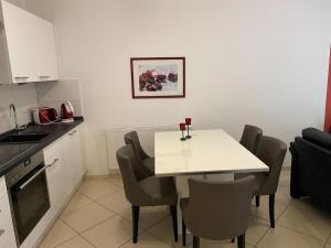 a small kitchen with a white table and chairs at Wohnung 73 in Horumersiel