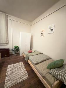 a bedroom with two beds and a window at Boldog Deluxe apartman in Szolnok