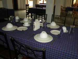 a blue and white table with plates and bowls on it at Fig Tree Lodge Camp in Mto wa Mbu