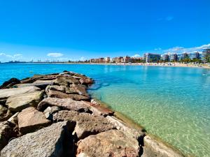 a view of a beach with rocks in the water at Bonita Planta baja con patio en 1ª línea de playa in Puerto de Sagunto