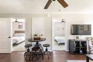 a living room with a table and a bedroom at Whitesboros Hidden Gem Cozy Downtown Haven in Whitesboro